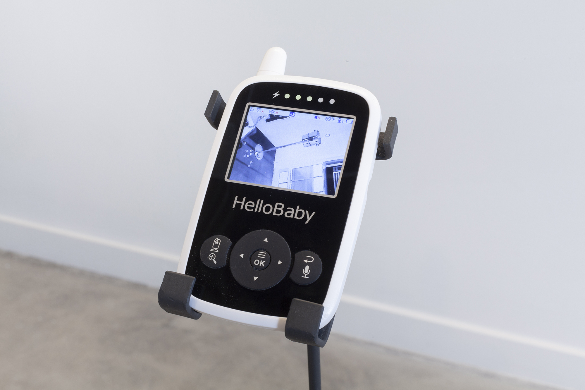 Detail image of one of the faces of the baby monitor. It provides live surveillance of a candle flickering in a pile of ice inside of a wine bucket. Pieces of ice cubes are strewn across the floor.